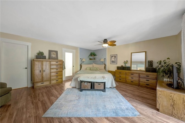 bedroom with a ceiling fan and wood finished floors