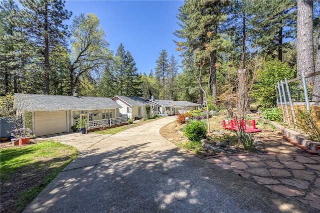 view of front of property with a garage, fence, and concrete driveway