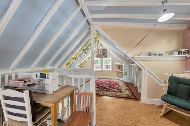 additional living space with vaulted ceiling with beams and wood finished floors