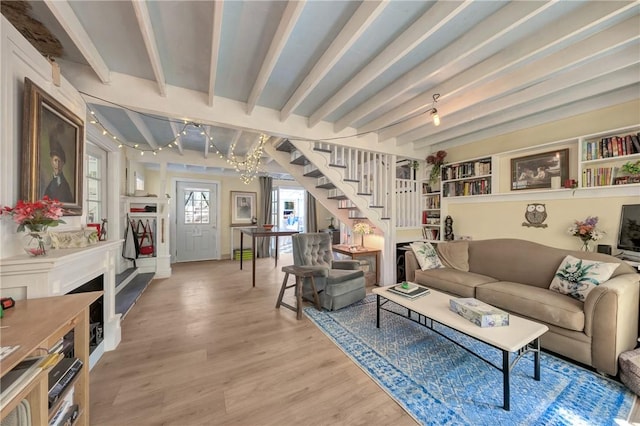 16675 Mountain View Dr, Cobb, CA 95426 - living room with light wood finished floors, beamed ceiling, stairs, and a chandelier