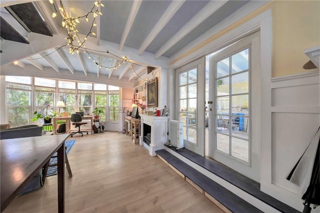 sunroom / solarium featuring french doors, a notable chandelier, beam ceiling, and wood finished floors