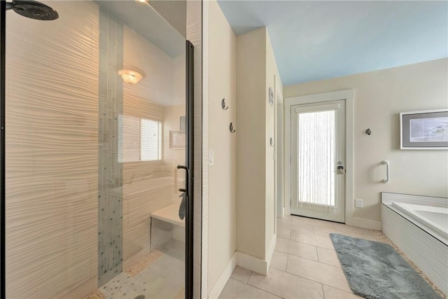 bathroom featuring baseboards, a stall shower, and tile patterned floors