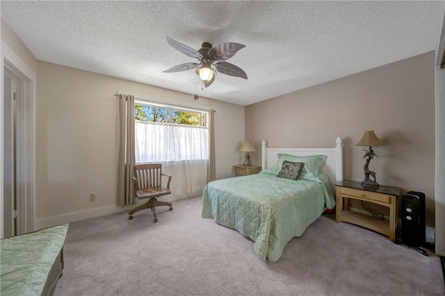 carpeted bedroom featuring baseboards, a ceiling fan, and a textured ceiling