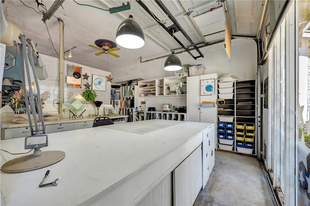 kitchen with a ceiling fan and concrete floors