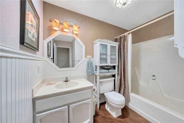 bathroom featuring vanity, toilet, wood finished floors, and shower / bath combination with curtain