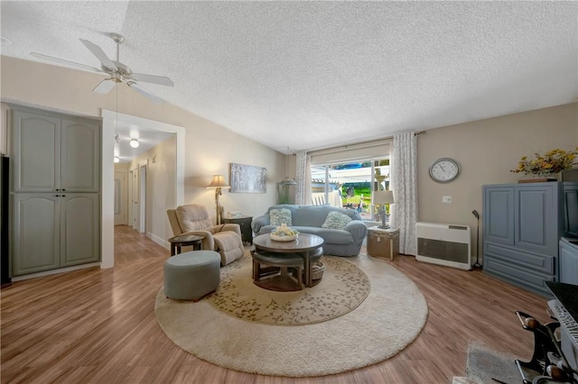 16675 Mountain View Dr, Cobb, CA 95426 - living room featuring a textured ceiling, wood finished floors, ceiling fan, lofted ceiling, and heating unit