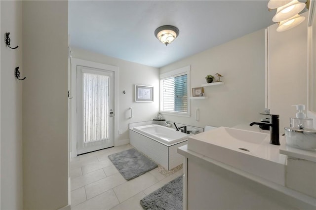 bathroom featuring a garden tub, tile patterned floors, and vanity