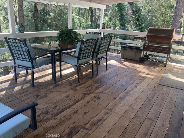 wooden terrace with outdoor dining space