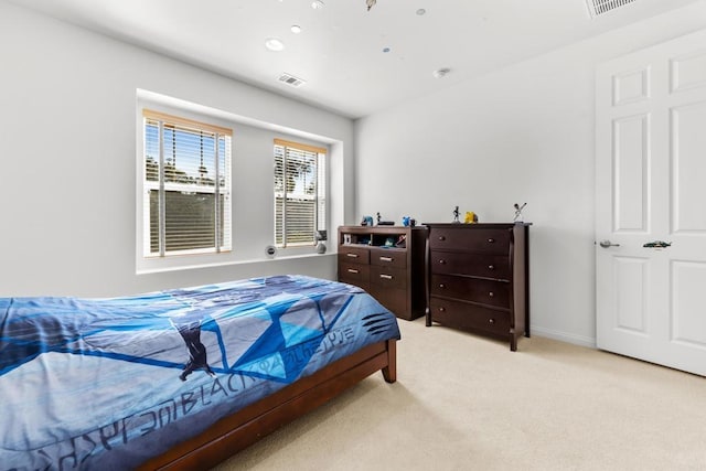 carpeted bedroom with baseboards and visible vents