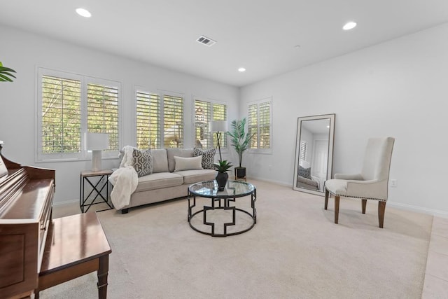 living room featuring plenty of natural light, baseboards, recessed lighting, and visible vents