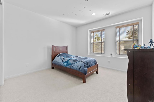 bedroom with baseboards, carpet flooring, and visible vents