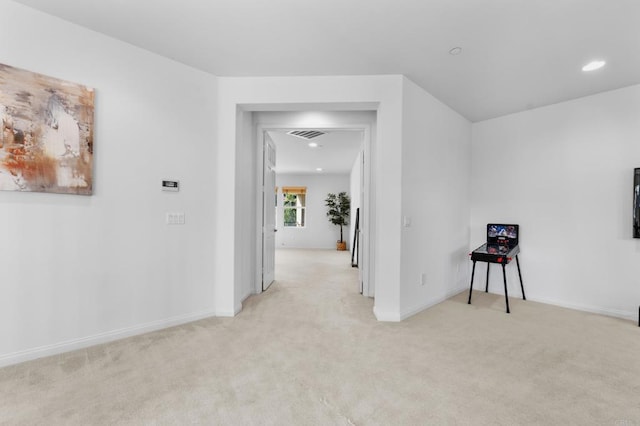 corridor featuring recessed lighting, light carpet, baseboards, and visible vents