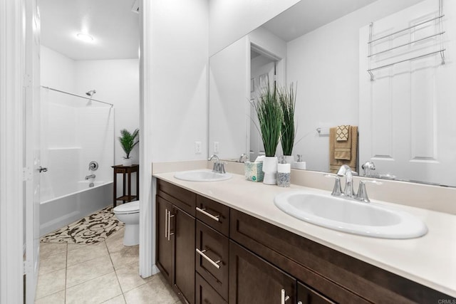 bathroom with double vanity, toilet, a sink, and shower / bathtub combination
