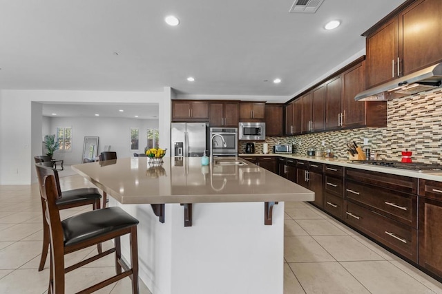 kitchen featuring a sink, visible vents, stainless steel appliances, and light tile patterned floors