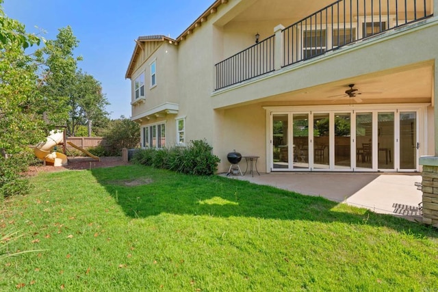 view of yard with ceiling fan and a patio area