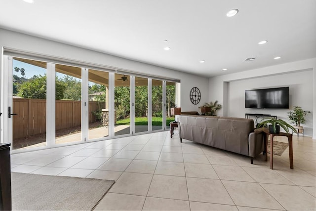 living room with light tile patterned floors, plenty of natural light, visible vents, and recessed lighting