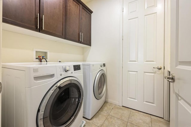 laundry room with light tile patterned flooring, cabinet space, independent washer and dryer, and baseboards
