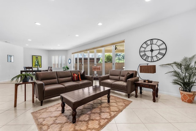 living room featuring light tile patterned floors, baseboards, and recessed lighting