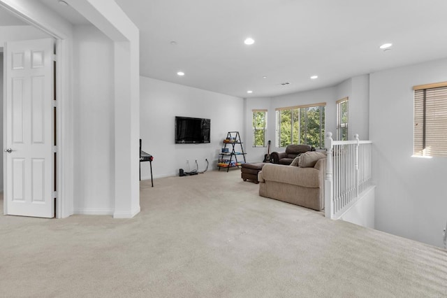living area featuring carpet flooring and recessed lighting