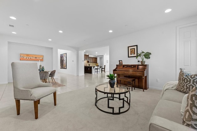 living area featuring recessed lighting, light tile patterned floors, baseboards, visible vents, and light carpet