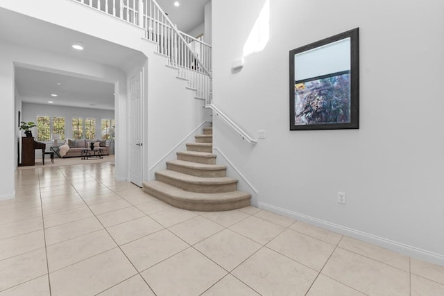 stairs featuring tile patterned floors, baseboards, and recessed lighting