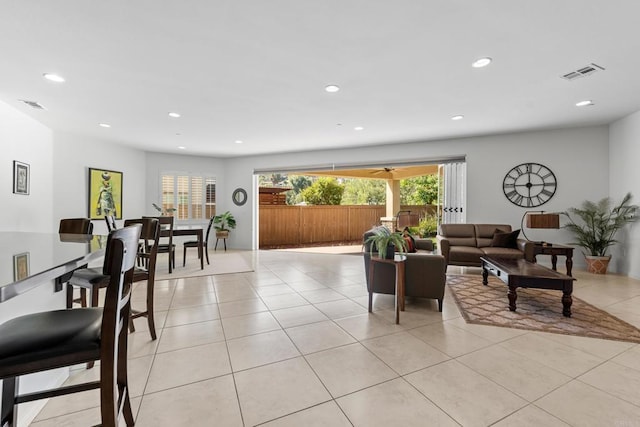 living area featuring light tile patterned flooring, visible vents, and recessed lighting