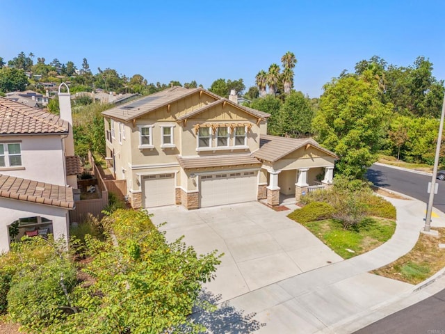 craftsman inspired home with stucco siding, stone siding, driveway, a garage, and a chimney