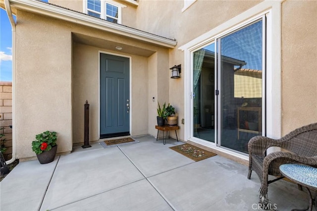 30688 Lone Pine Dr, Menifee, CA 92584 - property entrance featuring stucco siding and a patio area