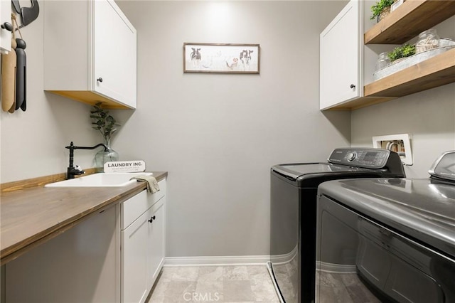 30688 Lone Pine Dr, Menifee, CA 92584 - washroom featuring washing machine and dryer, cabinet space, and baseboards