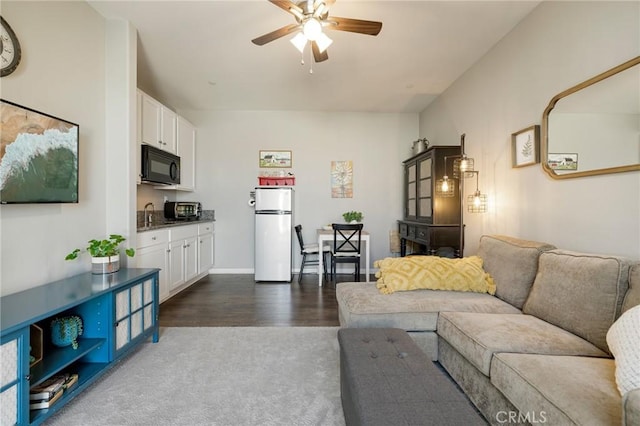30688 Lone Pine Dr, Menifee, CA 92584 - living area featuring ceiling fan, dark wood finished floors, and dark carpet