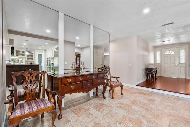 foyer entrance with recessed lighting, stone tile floors, visible vents, and baseboards