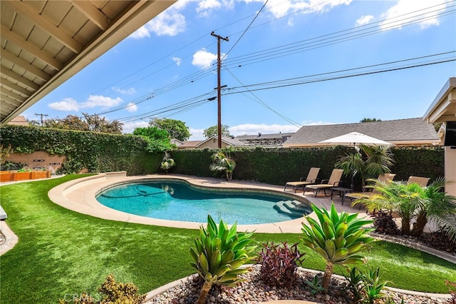 view of swimming pool featuring a fenced backyard, a fenced in pool, a lawn, and a patio area