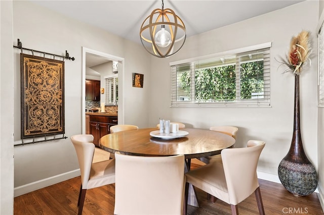 dining area with baseboards and dark wood finished floors