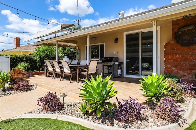 view of patio / terrace featuring grilling area, fence, and outdoor dining space
