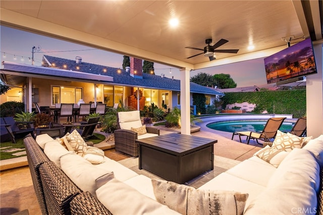 view of patio featuring a fenced in pool, ceiling fan, and outdoor lounge area