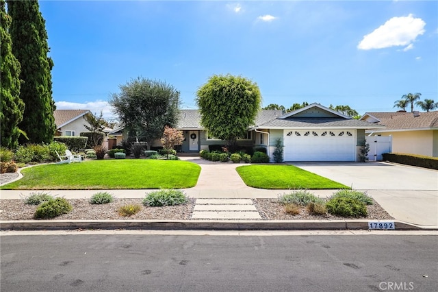 view of front of house featuring concrete driveway, a garage, fence, and a front lawn