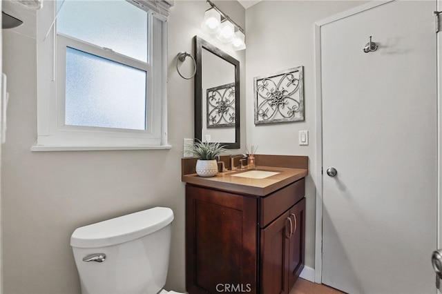 half bathroom featuring toilet and vanity