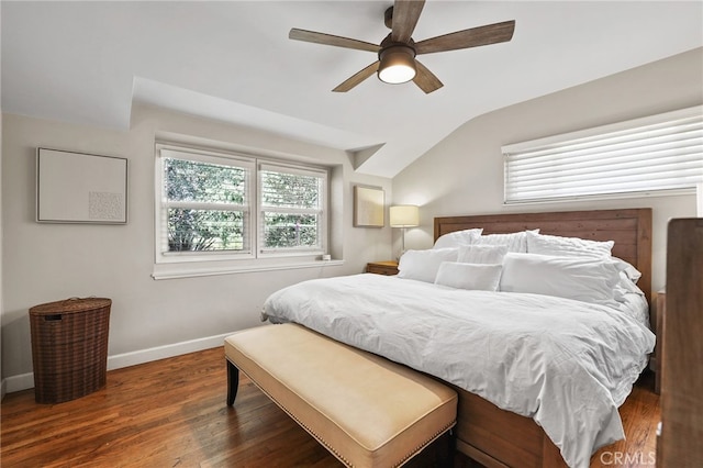 bedroom with baseboards, ceiling fan, wood finished floors, and vaulted ceiling