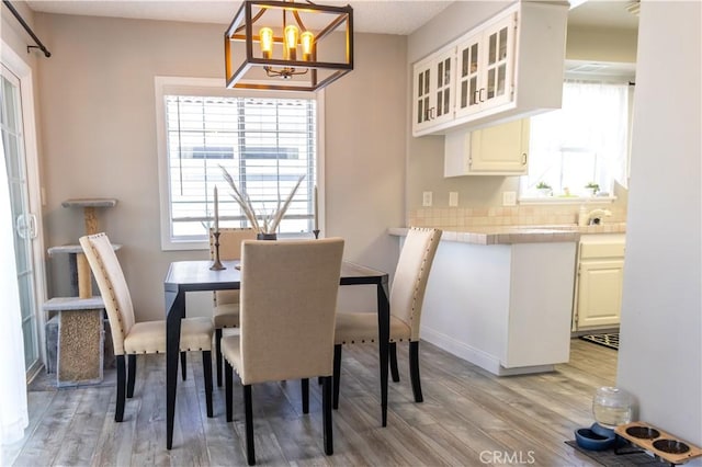 6151 Tyndall Dr, Huntington Beach, CA 92647 - dining room featuring light wood finished floors and a chandelier