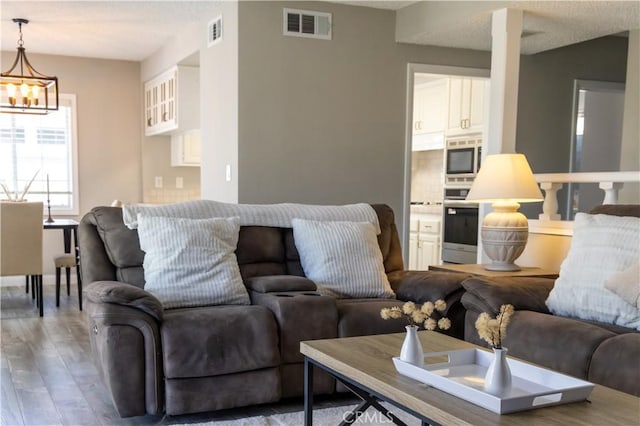 6151 Tyndall Dr, Huntington Beach, CA 92647 - living area featuring a chandelier, wood finished floors, and a textured ceiling