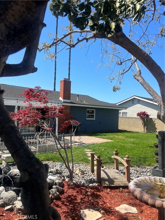 6151 Tyndall Dr, Huntington Beach, CA 92647 - rear view of house featuring a chimney, a patio, and a shingled roof