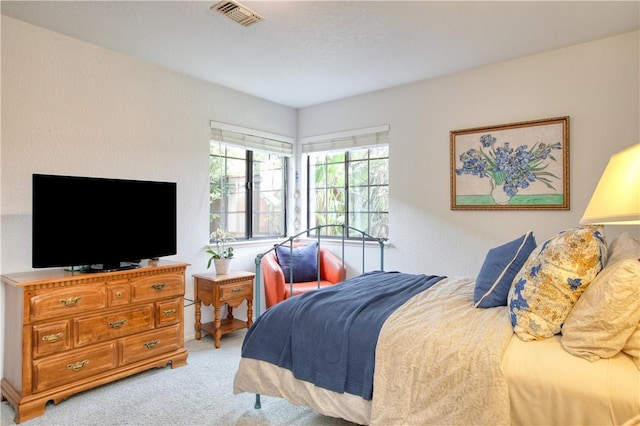 bedroom with light colored carpet and visible vents