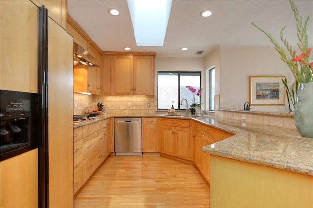 kitchen with stainless steel appliances, light brown cabinets, recessed lighting, and light wood-style floors