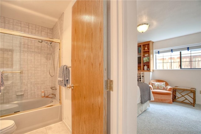 bathroom featuring shower / bathtub combination, toilet, baseboards, and tile patterned floors
