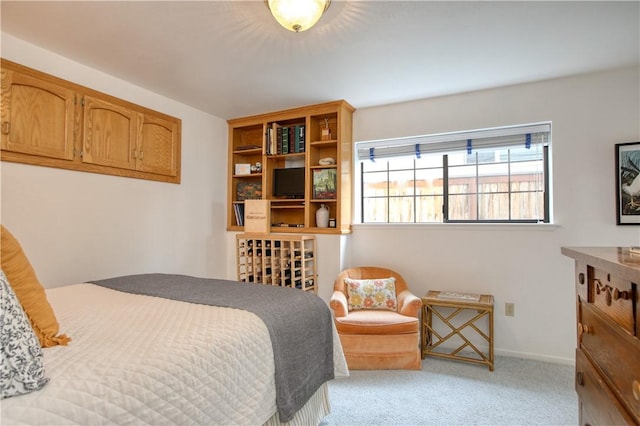 carpeted bedroom featuring baseboards