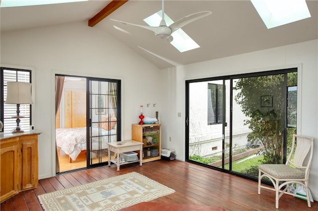 interior space with hardwood / wood-style floors, plenty of natural light, lofted ceiling with skylight, and ceiling fan