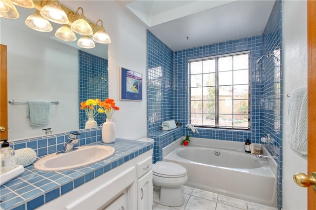 bathroom featuring a washtub, vanity, a shower, toilet, and tile patterned flooring