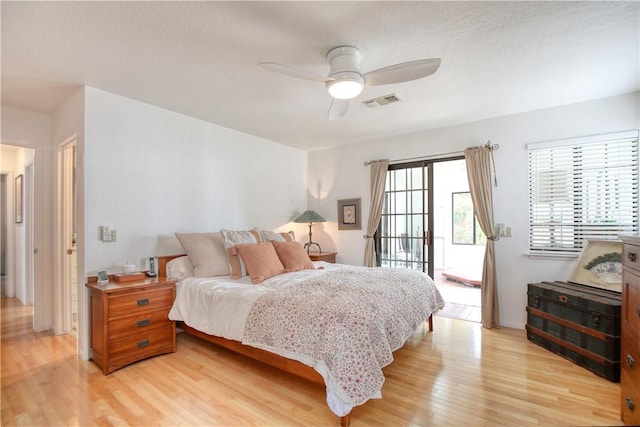 bedroom with visible vents, light wood-style floors, a textured ceiling, access to outside, and ceiling fan