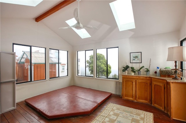 unfurnished sunroom featuring a skylight and beam ceiling