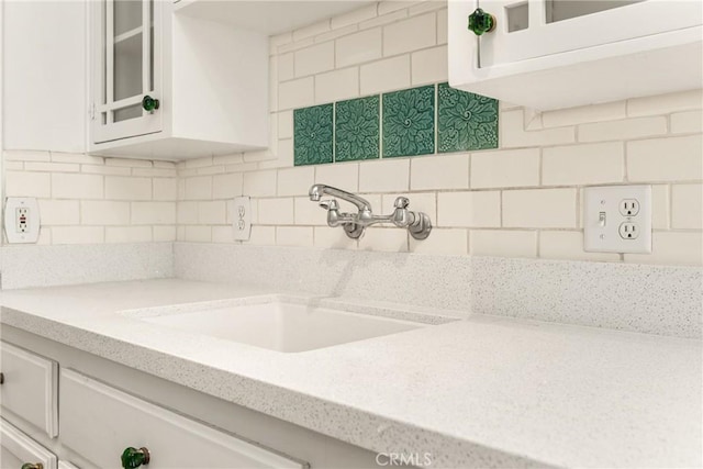 455 E Ocean Blvd Unit 411, Long Beach, CA 90802 - kitchen with a sink, glass insert cabinets, white cabinetry, and backsplash